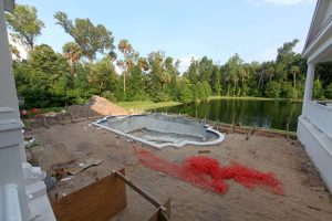 inground-pool-construction-beside-lake-central-florida-pool-builders