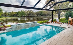 inground pool spillover waterwall screened enclosure lake view florida