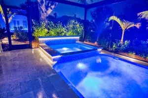 luxury spa elevated hot tub blue led lighting screened enclosure night florida