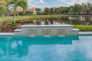 custom pool sheer descent waterwall mosaic tile lakefront florida
