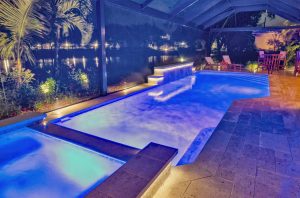 custom pool spa waterfall blue led lighting lakefront night florida