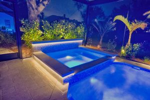 custom spa mosaic tile sheer descent blue led lighting night florida