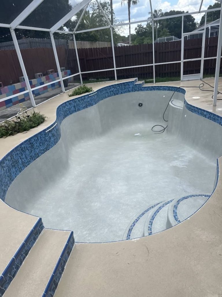 empty curved residential pool construction
