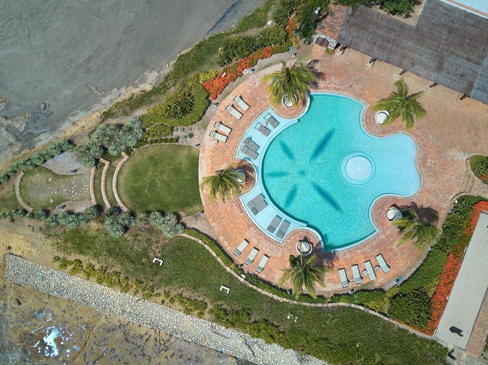 Aerial view of a completed freeform swimming pool that homeowners can review when checking for pool builder red flags